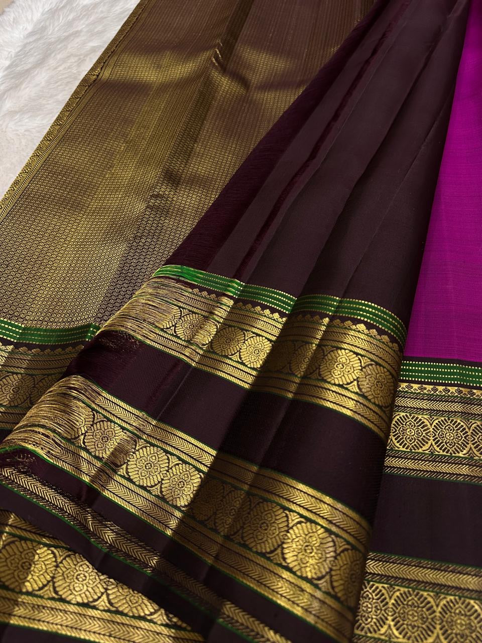 Magenta silk body detail showing larger gold zari buttas.
