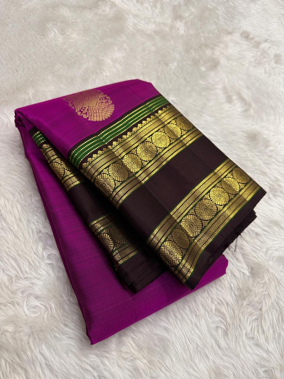 Displayed magenta pink handwoven Kanjivaram rettapet saree.
