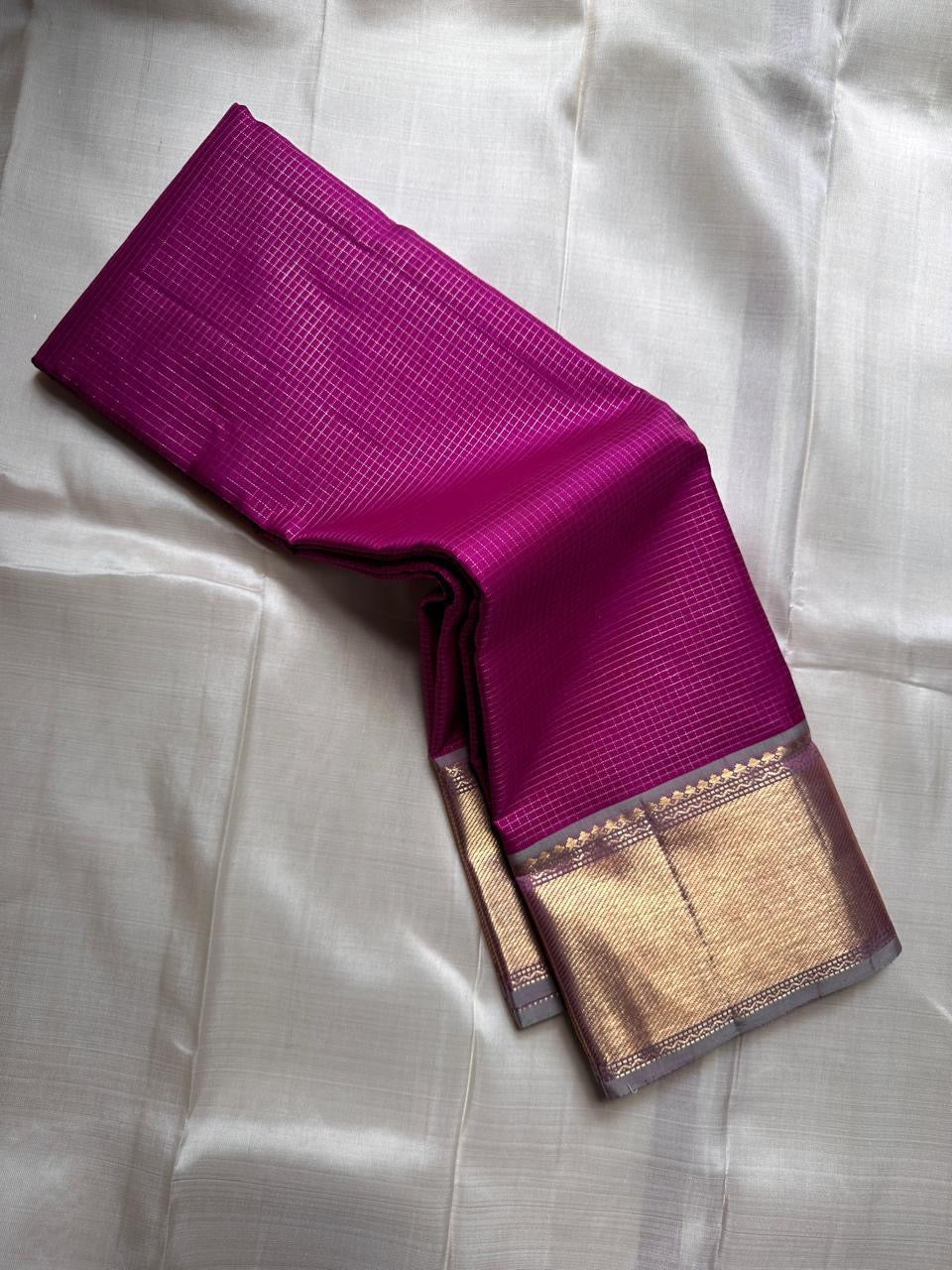 Magenta Pure Silk Kanchipuram saree with a broad Getti zari border.