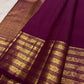 Gold-rich pallu on the deep brown Kanchipuram butta saree.