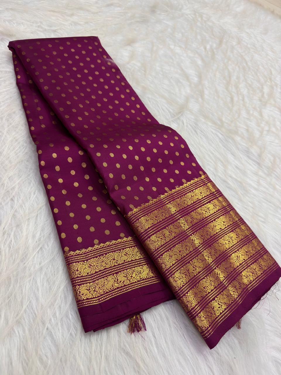Deep brown body detail showing orderly rows of round zari buttas.