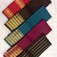 Close-up of round gold buttas on the deep brown silk body.