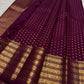 Displayed deep brown handwoven Kanchipuram butta saree.