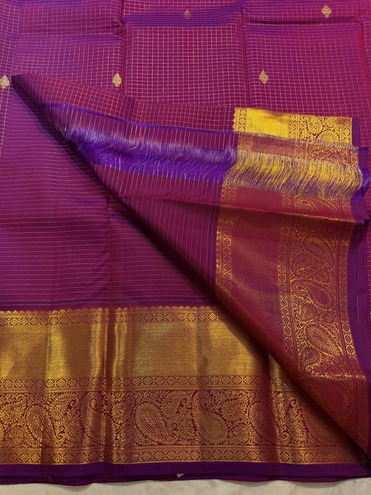 Rich gold zari pallu of magenta purple Kanchipuram saree