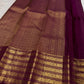 Varisaipet border detail on the deep brown Kanchipuram saree.