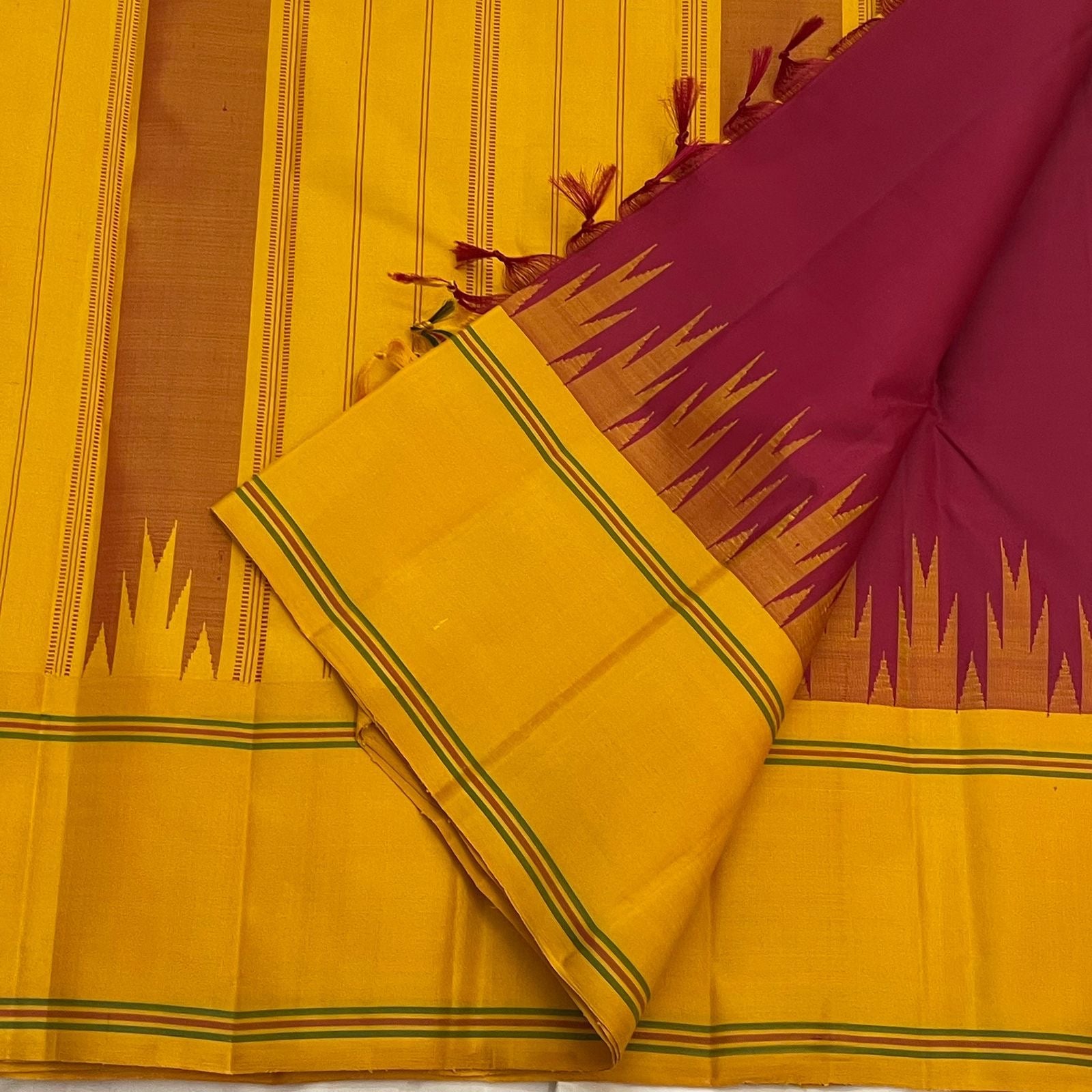 Canary yellow Korvai border of deep arakku red Kancheepuram saree with Thazhampoo Reku temple edge in coloured silk thread