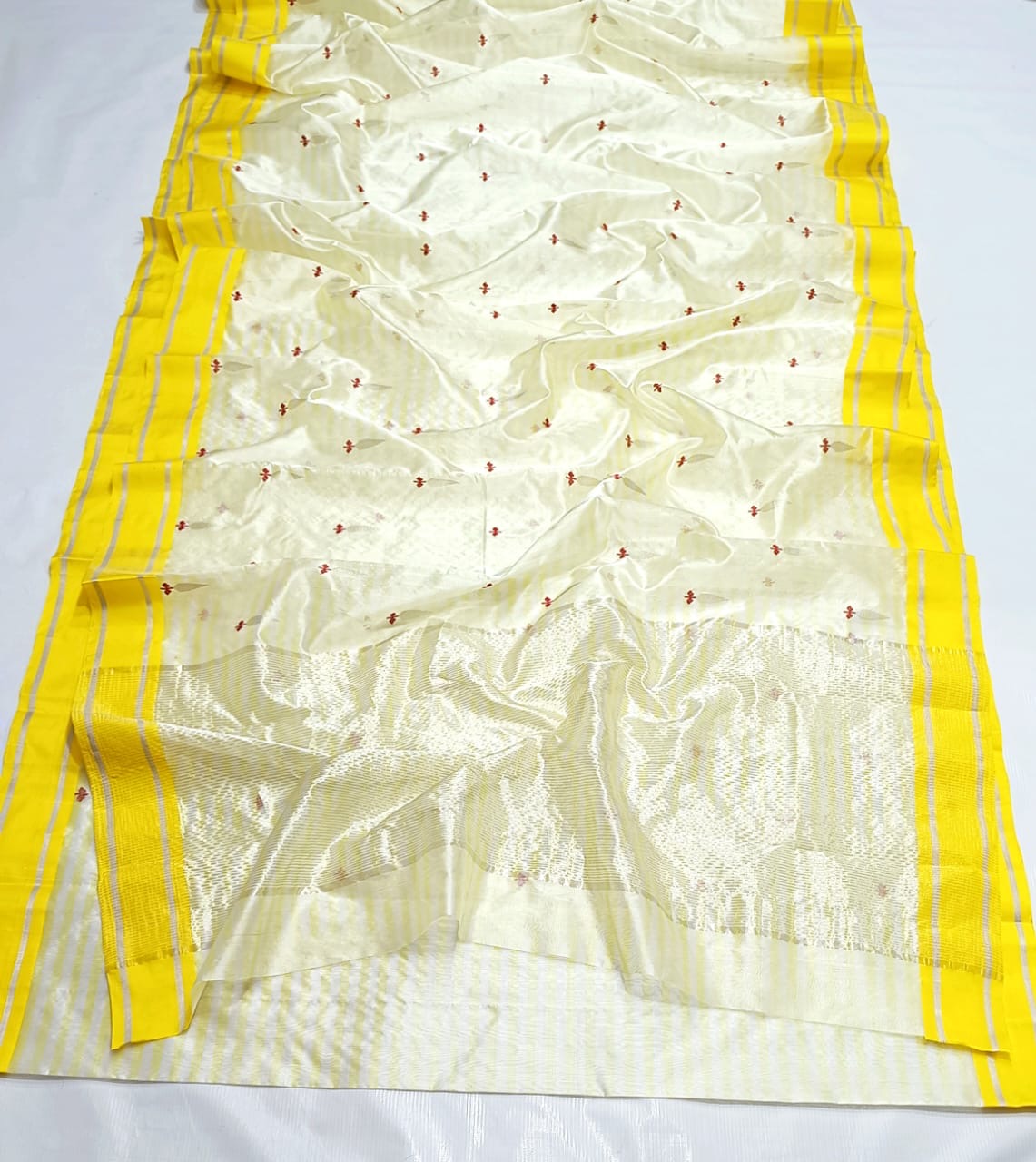 Moonlit ivory Chanderi Pattu Silk saree, alternate view with tiny rust-red florals and coordinating striped blouse fabric.