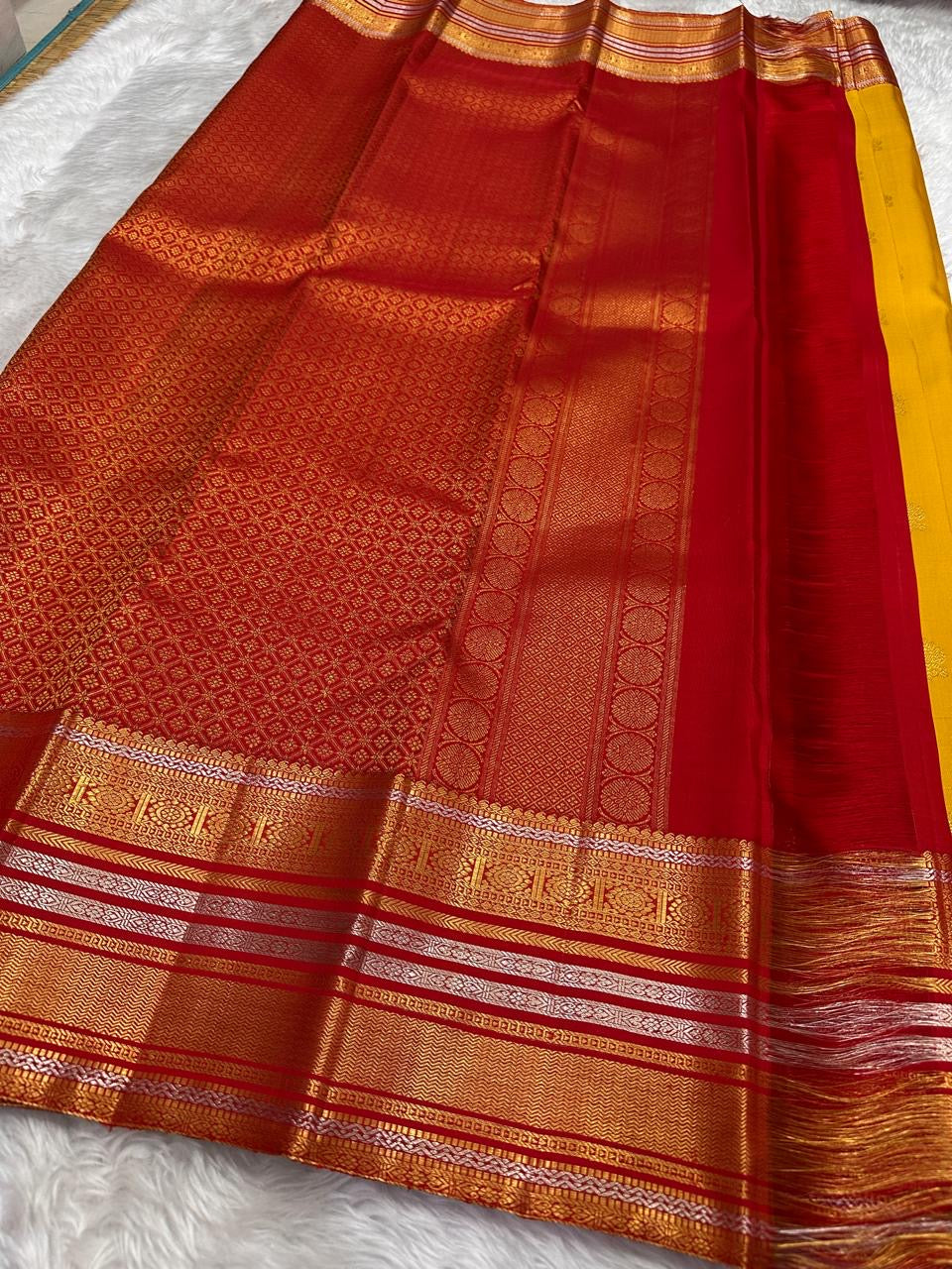 Manjal Kanjivaram silk saree with petite Poo Buttas and layered Varisaipet border
