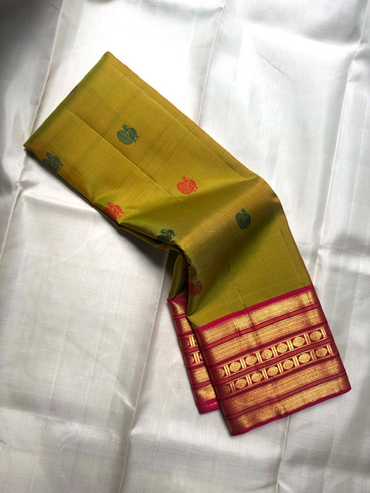 Green and pink Kanjivaram silk saree with traditional antique gold zari detailing