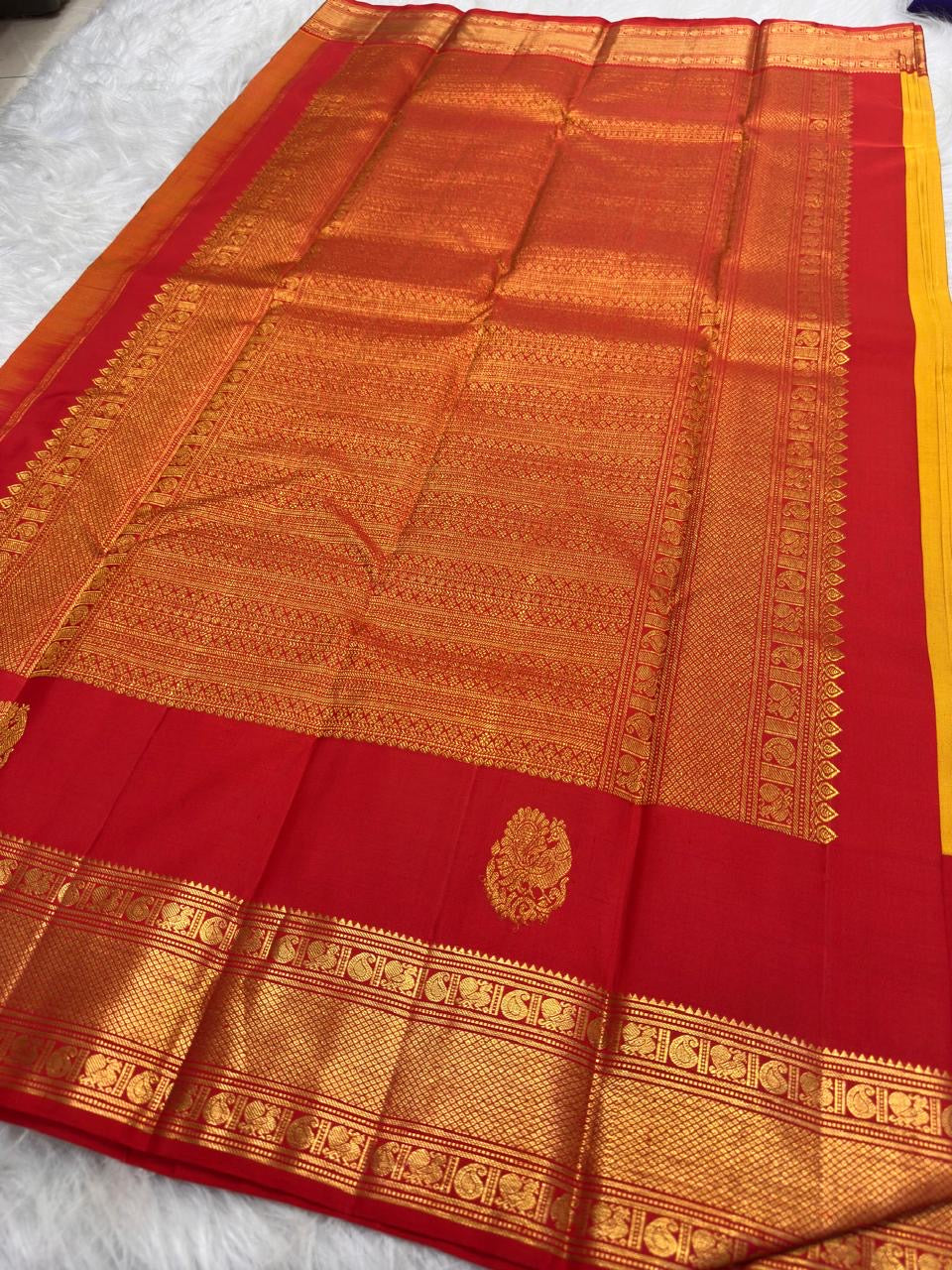 Manjal Yellow Kanjivaram silk saree with gold-zari ornament.
