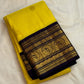 Full view of vivid manjal-yellow Vairaoosi silk with a deep navy and gold peacock border
