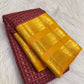 Varisaipet border detail on the plum purple and yellow Kanchipuram saree.