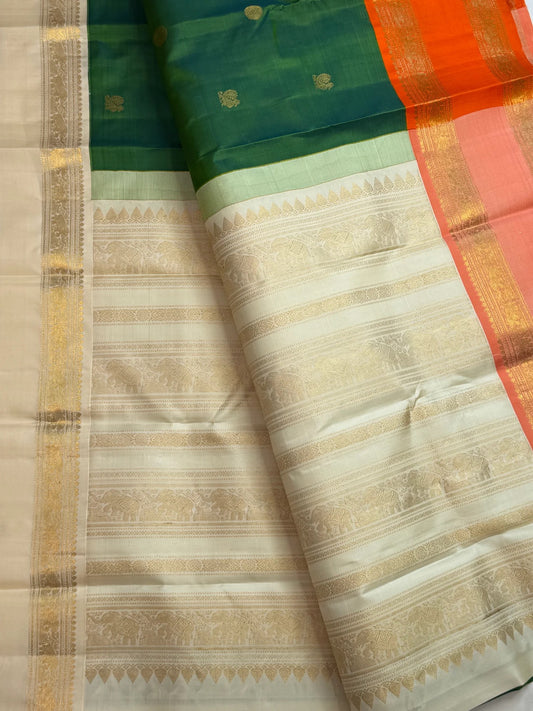 Double-shot leaf-to-emerald green with golden-mustard light pure silk Kanchipuram saree, ganga jamuna ivory orange border; traditional Rettapet weave.