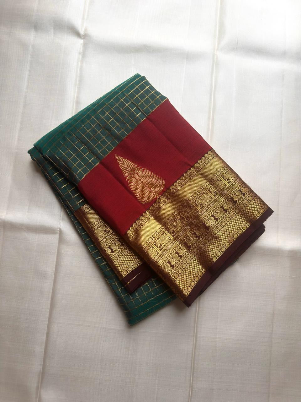 Maragatham Green Kanchipuram Zari Kattam saree with Paaku Brown gold-zari border.