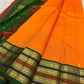 Marigold orange Pure Silk Kanchipuram saree with green layered varisaipet border and petite zari buttas.