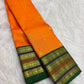Marigold orange handwoven Kanchipuram varisaipet silk saree with Maragatham green border.