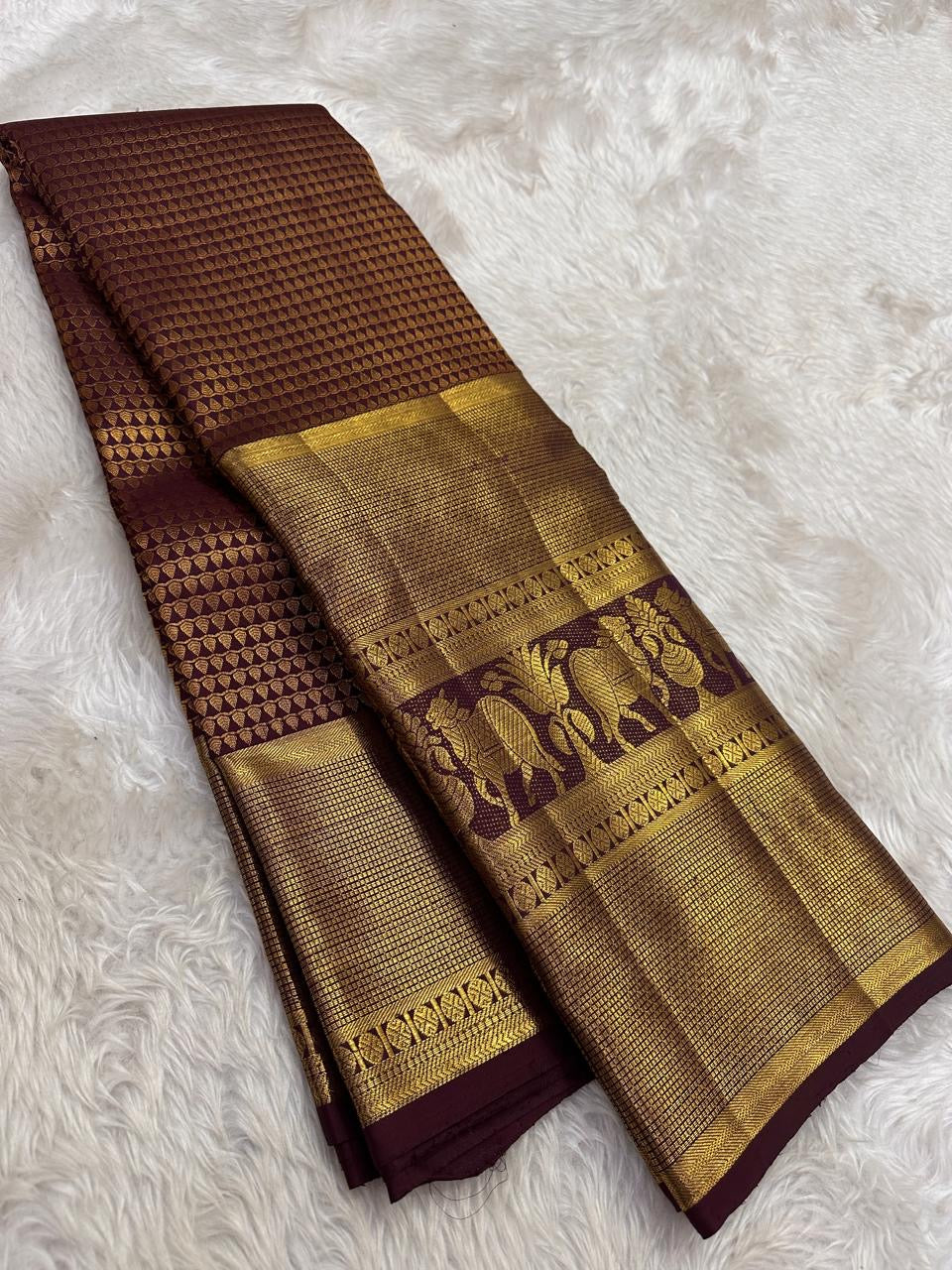 Traditional elephant motifs woven in antique gold across extra-wide Kanchipuram border.
