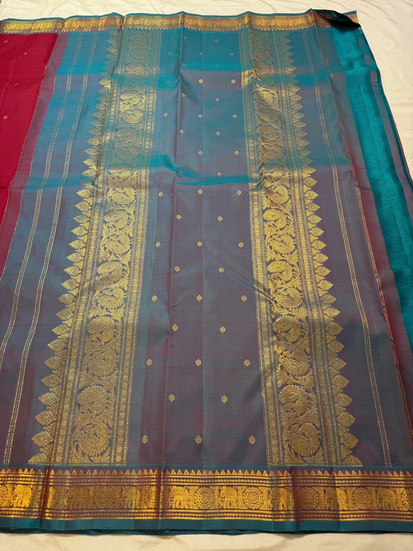 Close-up of Kamalam Butta gold-zari motifs on maroon Kancheepuram silk body