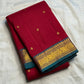 Pallu detail showing teal ground with gold elephant and chakra medallions, maroon Kancheepuram saree