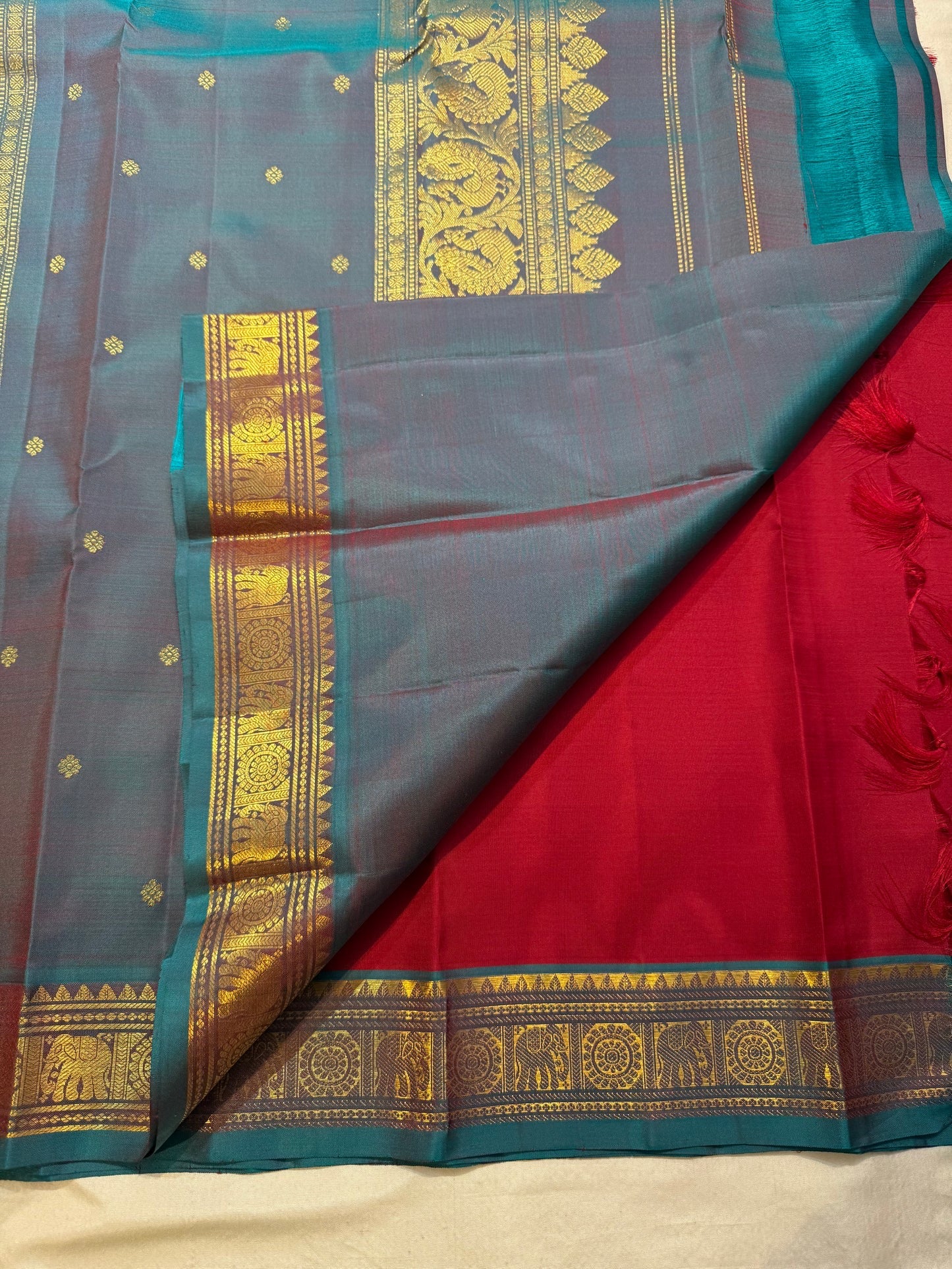 Maroon Butta Kancheepuram silk saree folded, showing full drape and border