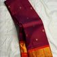 Deep Ennai Arakku Pure Silk Kanchipuram Butta saree with Orange border.