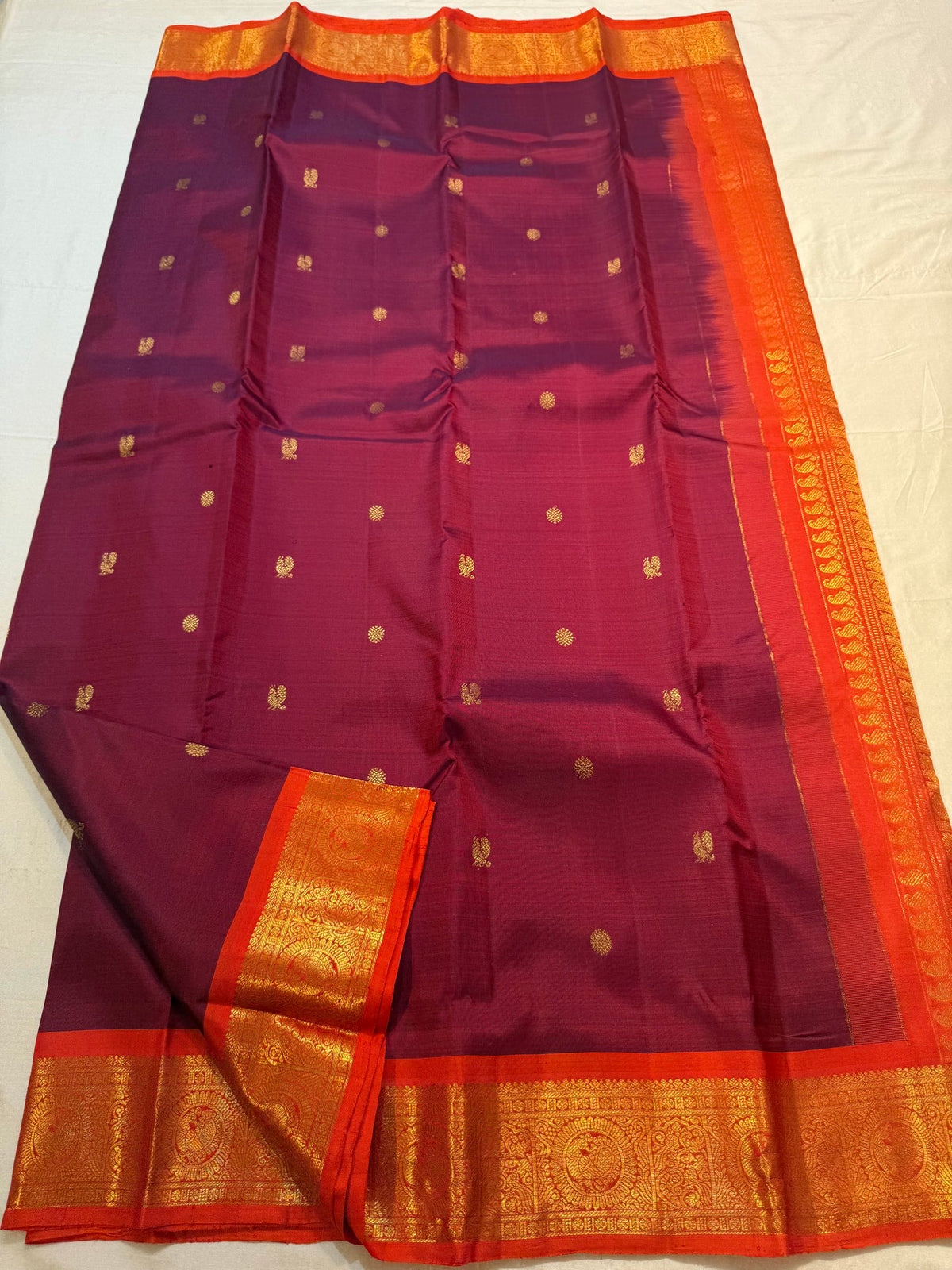 Fiery Orange border with rich traditional gold zari.