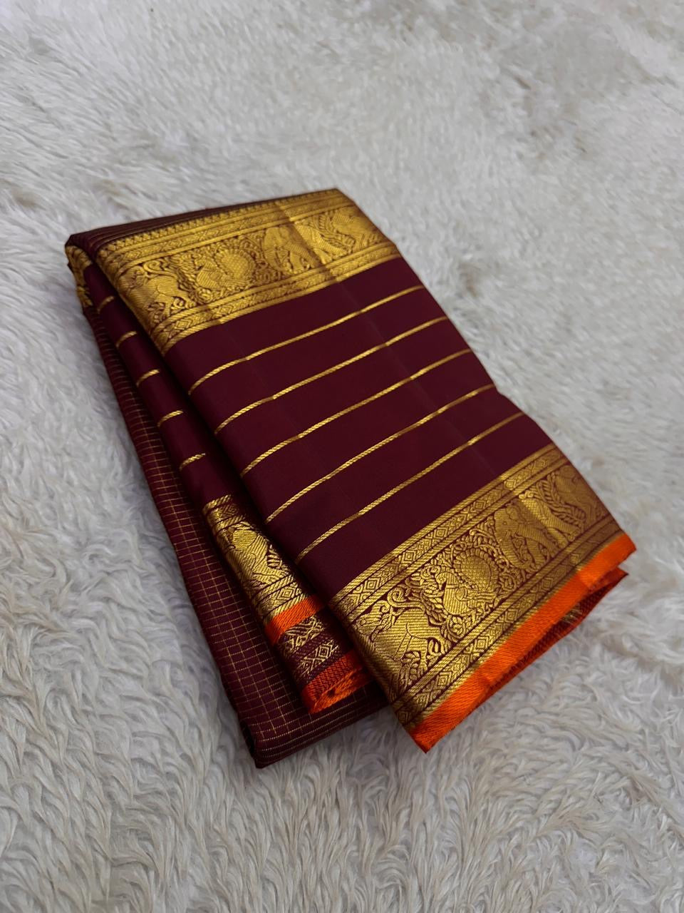 Handwoven Varisaipet saree with antique-gold peacock border and Burnt Orange selvedge.