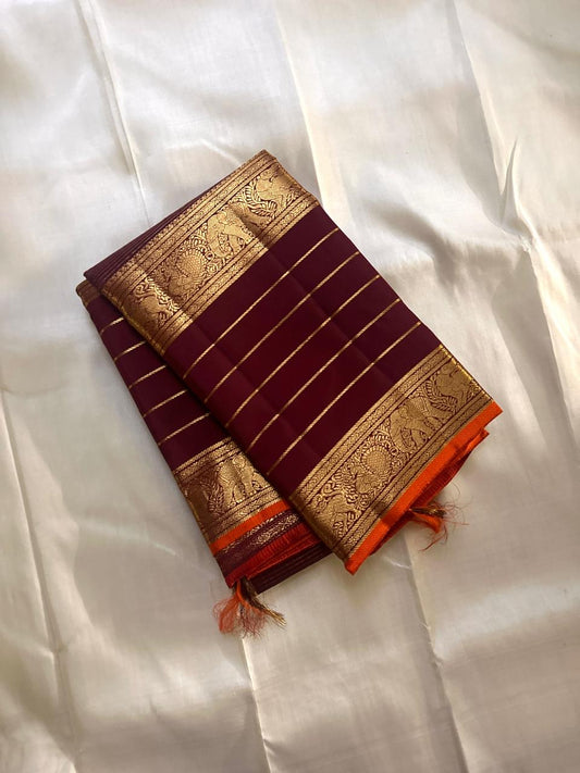 Maroon Kanchipuram silk saree with antique gold zari border laid flat