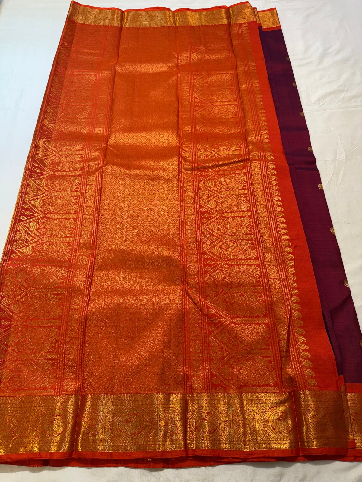 Gold-zari medallion detailing within the Orange border.