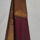 Close-up of ettukol gold zari border on maroon handwoven Kanchipuram saree — Idam Living