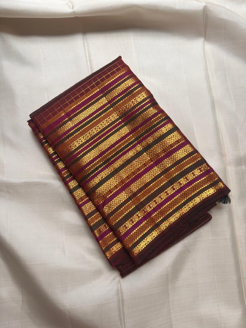 Deep cocoa maroon Kanjivaram saree with gold zari, pallu detail