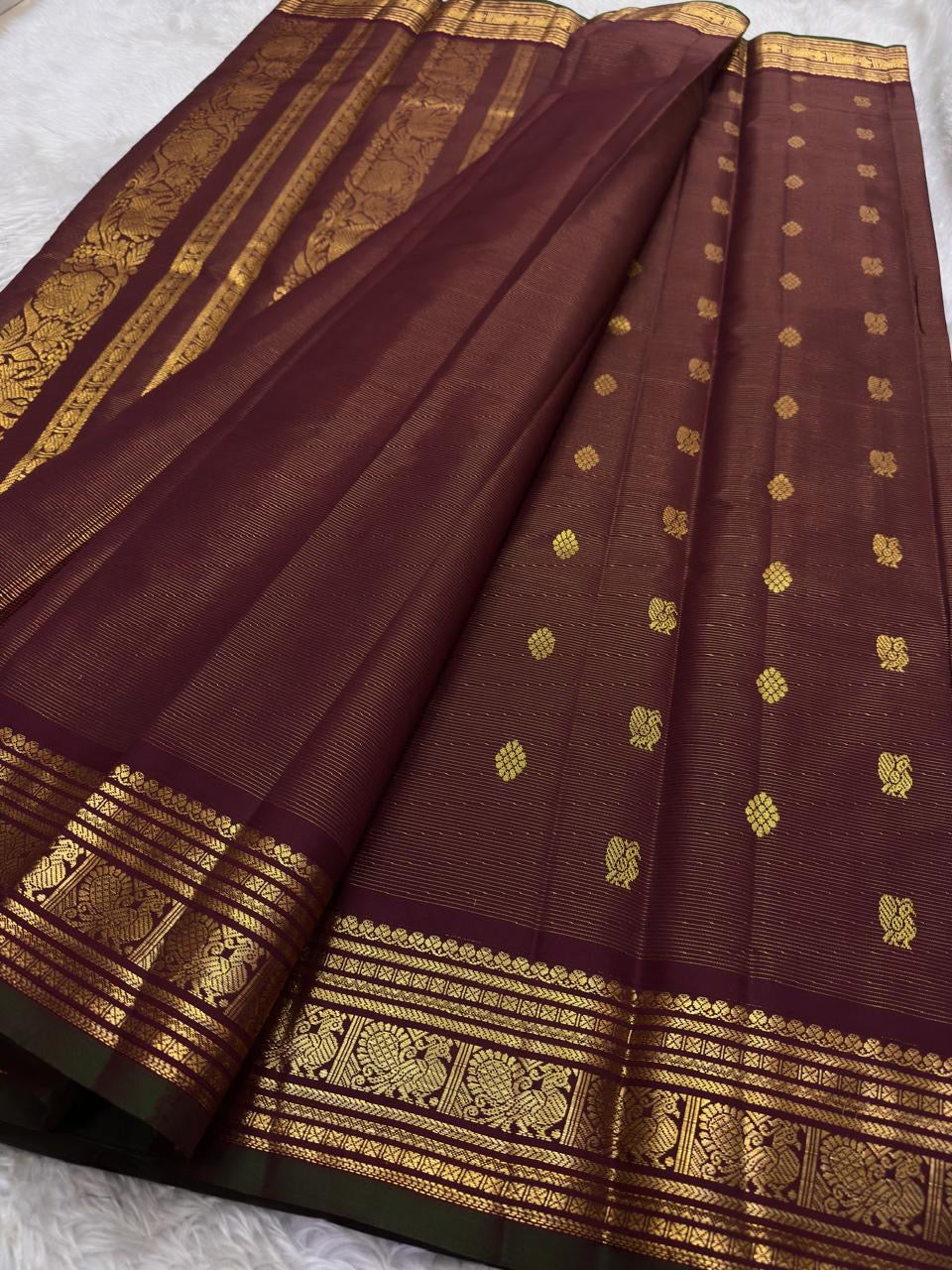 Close-up of mayil peacock butta motif in gold zari on maroon Kanjivaram handwoven silk saree — Idam Living