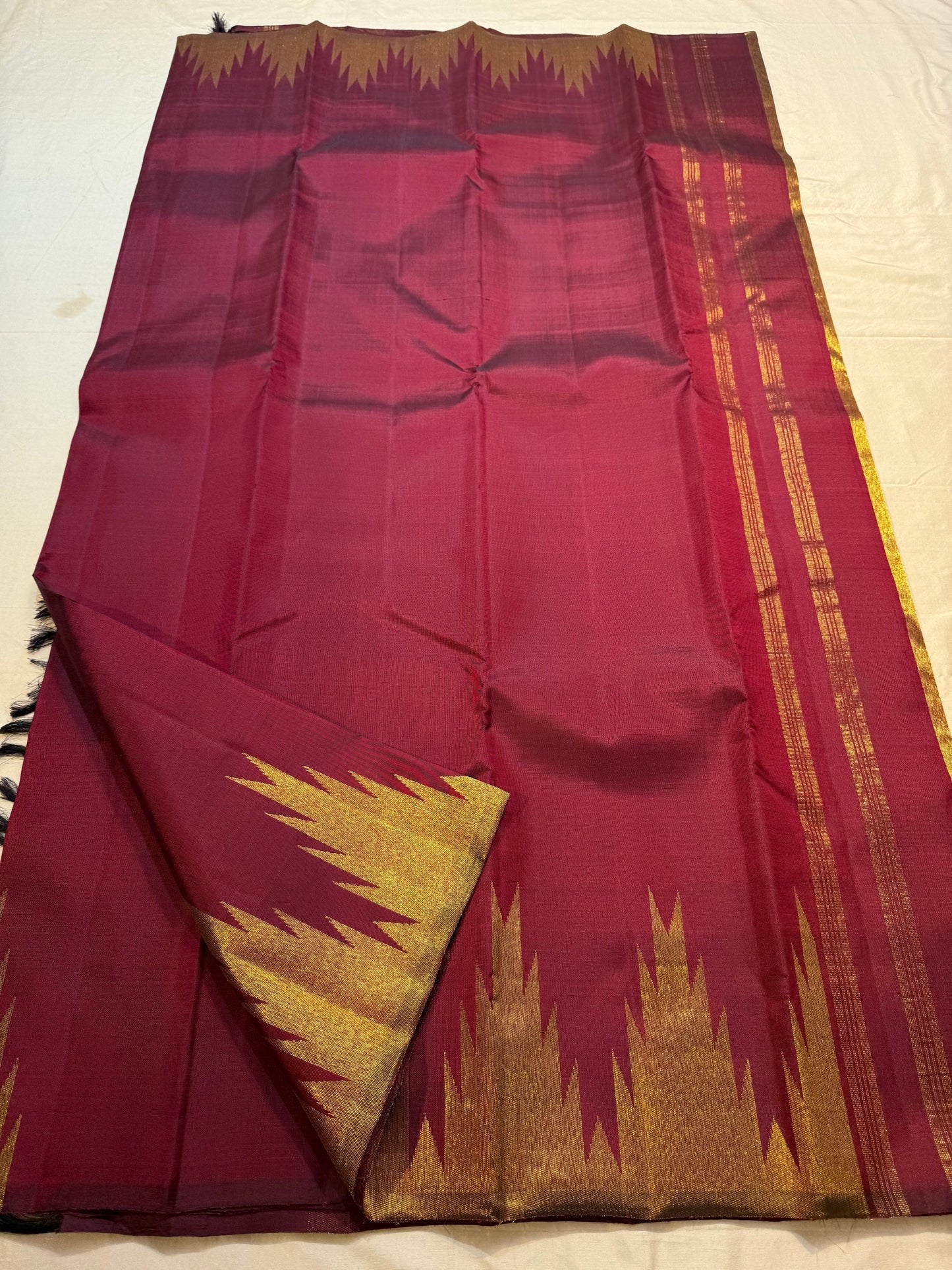 Deep maroon Kanjivaram silk saree with Ettukol temple border