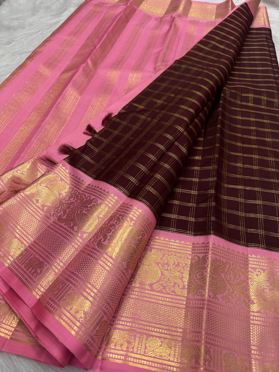 Deep maroon Kanjivaram Zari Kattam saree with a pink peacock zari border.