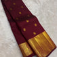 Gold zari mayil chakram peacock-wheel butta detail on maroon body