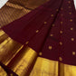 Gold zari peacock-and-bird pallu detail on maroon saree