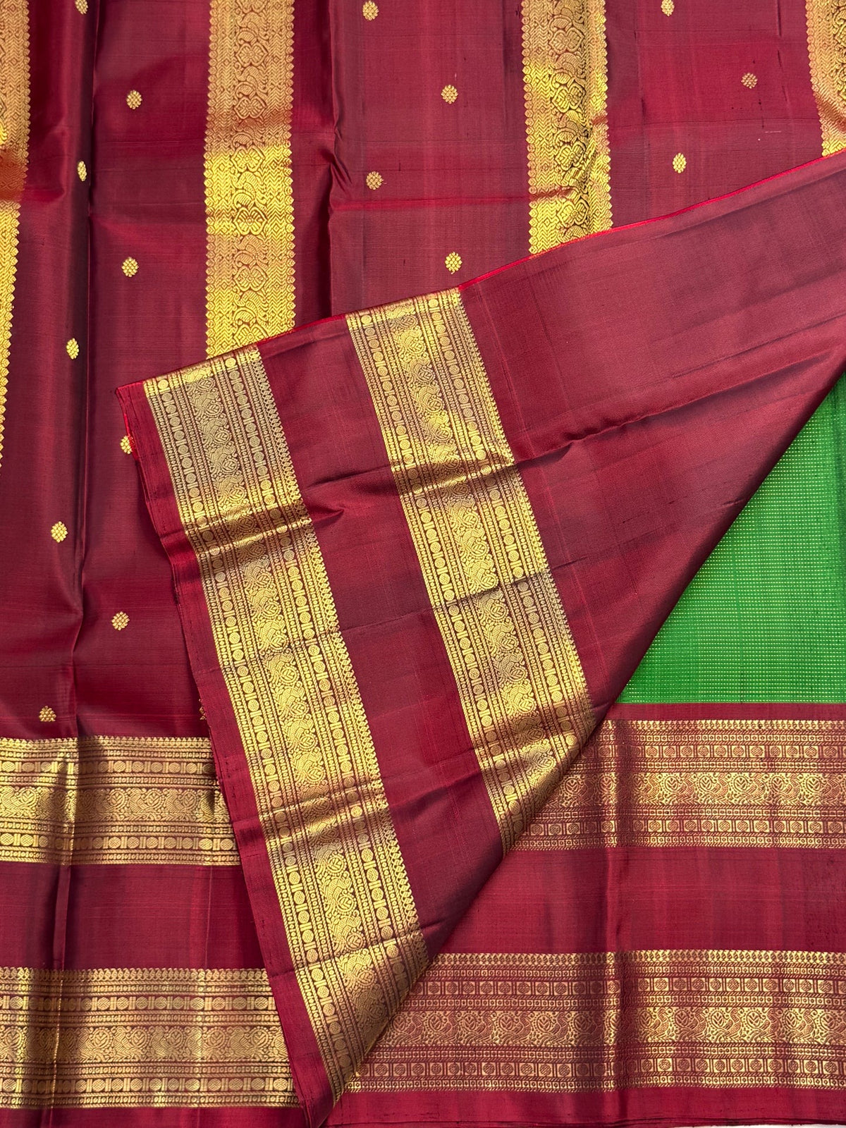 Maroon Kanjivaram border with ornate gold zari peacock motifs