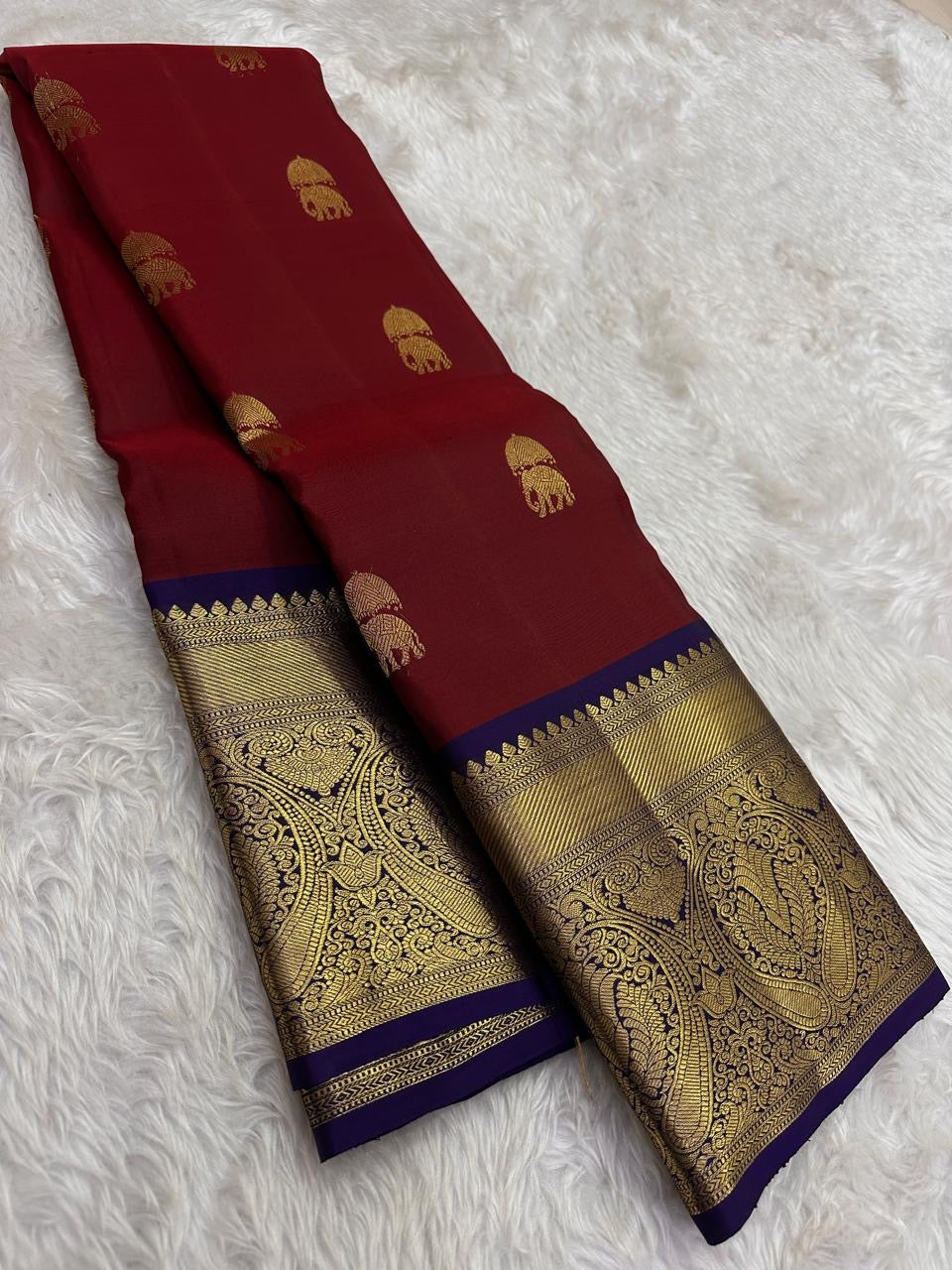 Arakku maroon Elephant Ambari Butta Kanchipuram saree with a broad purple gold zari border
