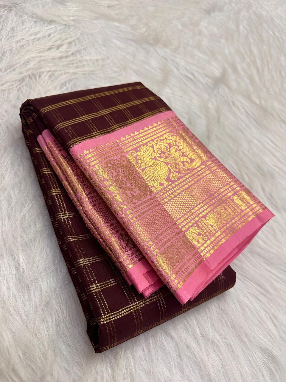 Maroon Pure Silk Kanchipuram saree with traditional gold zari work.