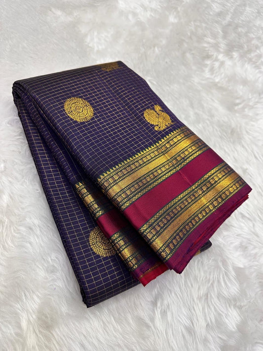 Folded deep plum purple Pure Kanchipuram silk saree with fine checked weave, gold zari woven motifs, and maroon zari woven border