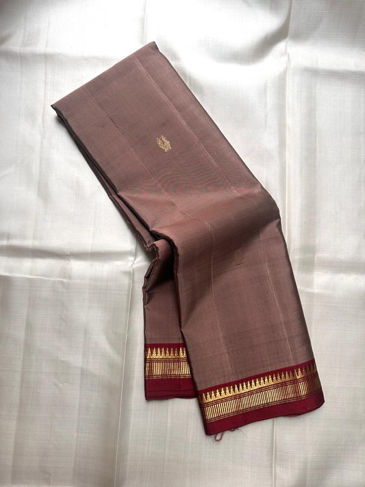 Folded pure Kanchipuram silk saree in beige with narrow maroon border and metallic zari detailing available in the USA