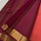 coral pink pure kanchipuram silk saree neatly folded showing narrow gold zari border