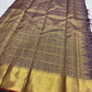 Close view of green silk-thread meenakari centre inside an antique-gold zari butta.