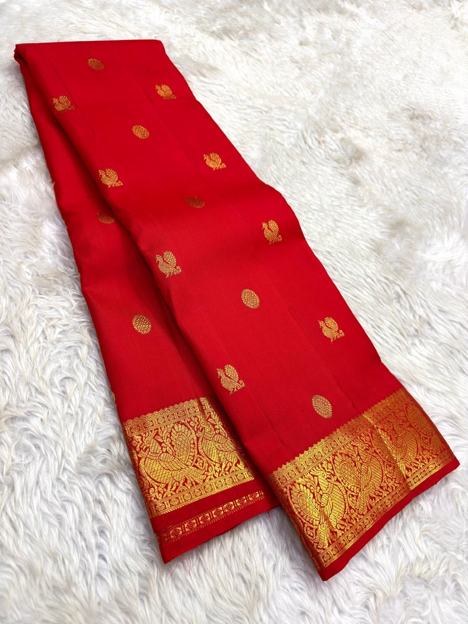Mayil butta Kanchipuram saree vermillion red – close-up of peacock motifs
