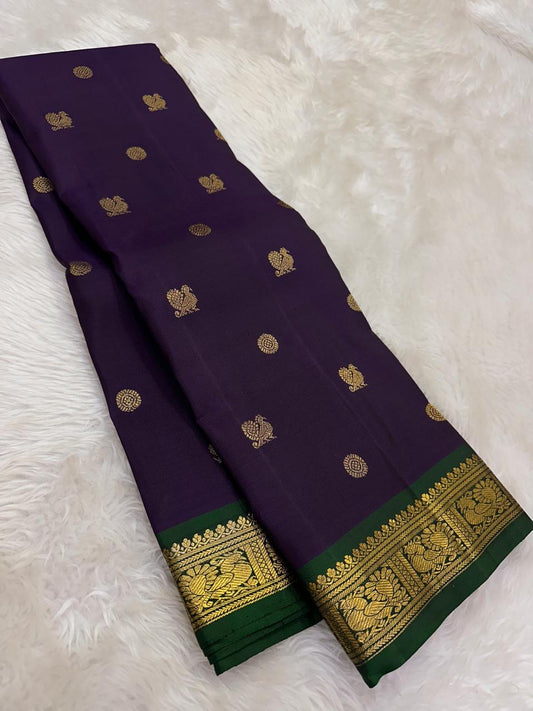 Mayil and Chakram zari buttas across deep violet silk body