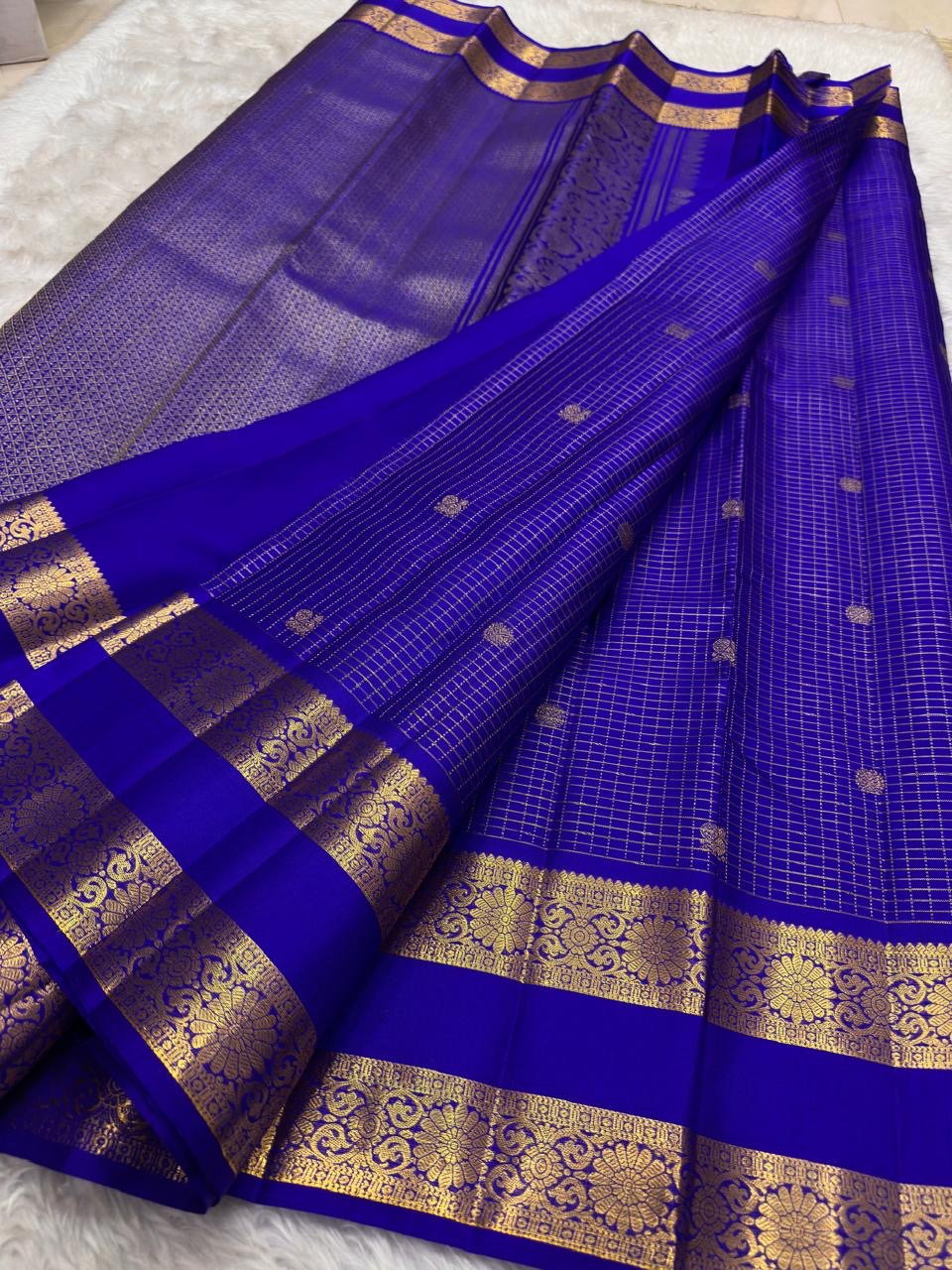 Self-colour pallu of royal blue Kancheepuram pure silk saree with cascading Kamalam and Mayil ornate antique gold zari
