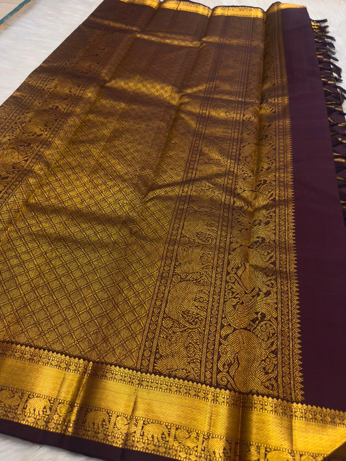 Mayil Chakram zari motif detail on the deep aubergine Kanchipuram saree