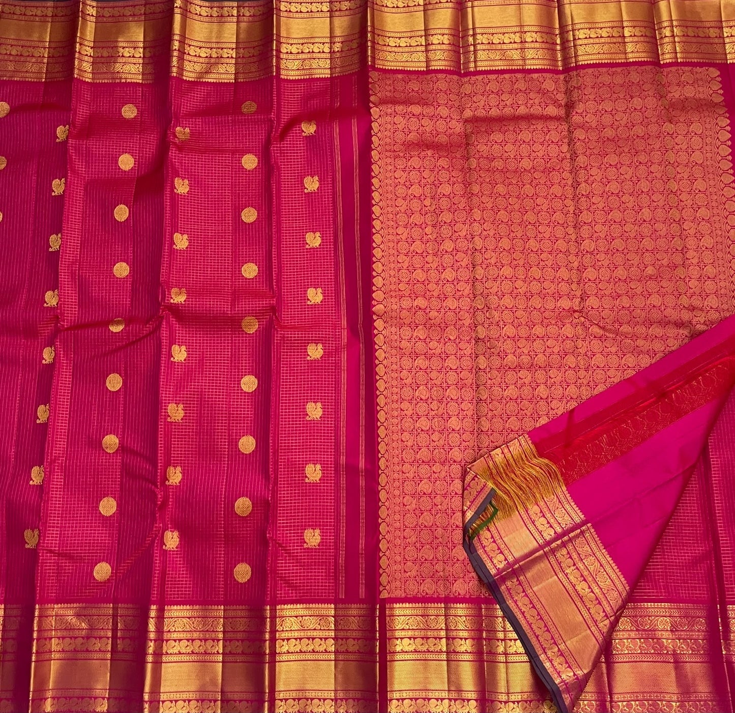 Mayil Chakram zari motif detail on the fuchsia pink Kanchipuram saree