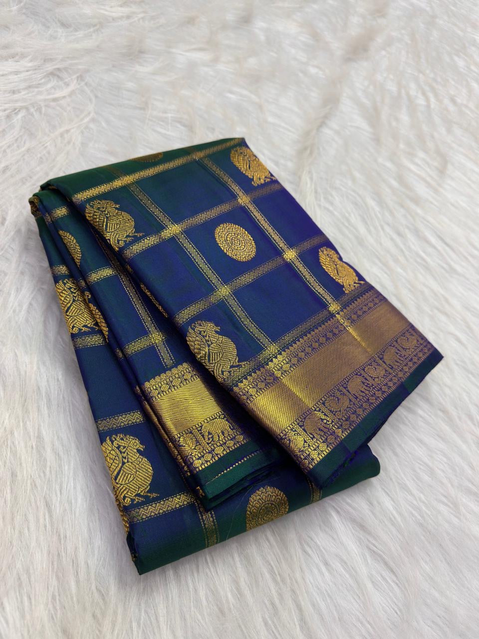 Mayil Chakram zari motif detail on the royal teal blue Kanchipuram saree