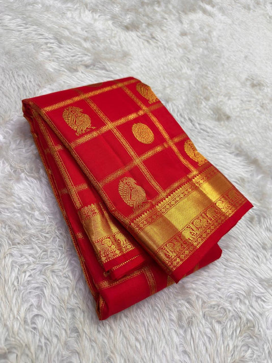 Mayil Chakram zari motif detail on the vermilion orange Kanchipuram saree
